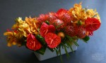 orange-red-and-yellow floral arrangement delivered gold coast