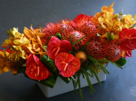 orange-red-and-yellow floral arrangement delivered gold coast