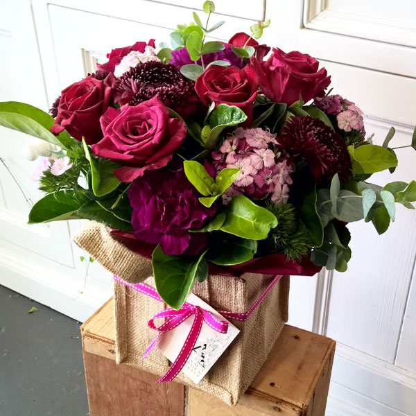 floral arrangement in hessian bag